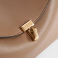 Toteme T-Lock leather clutch camel