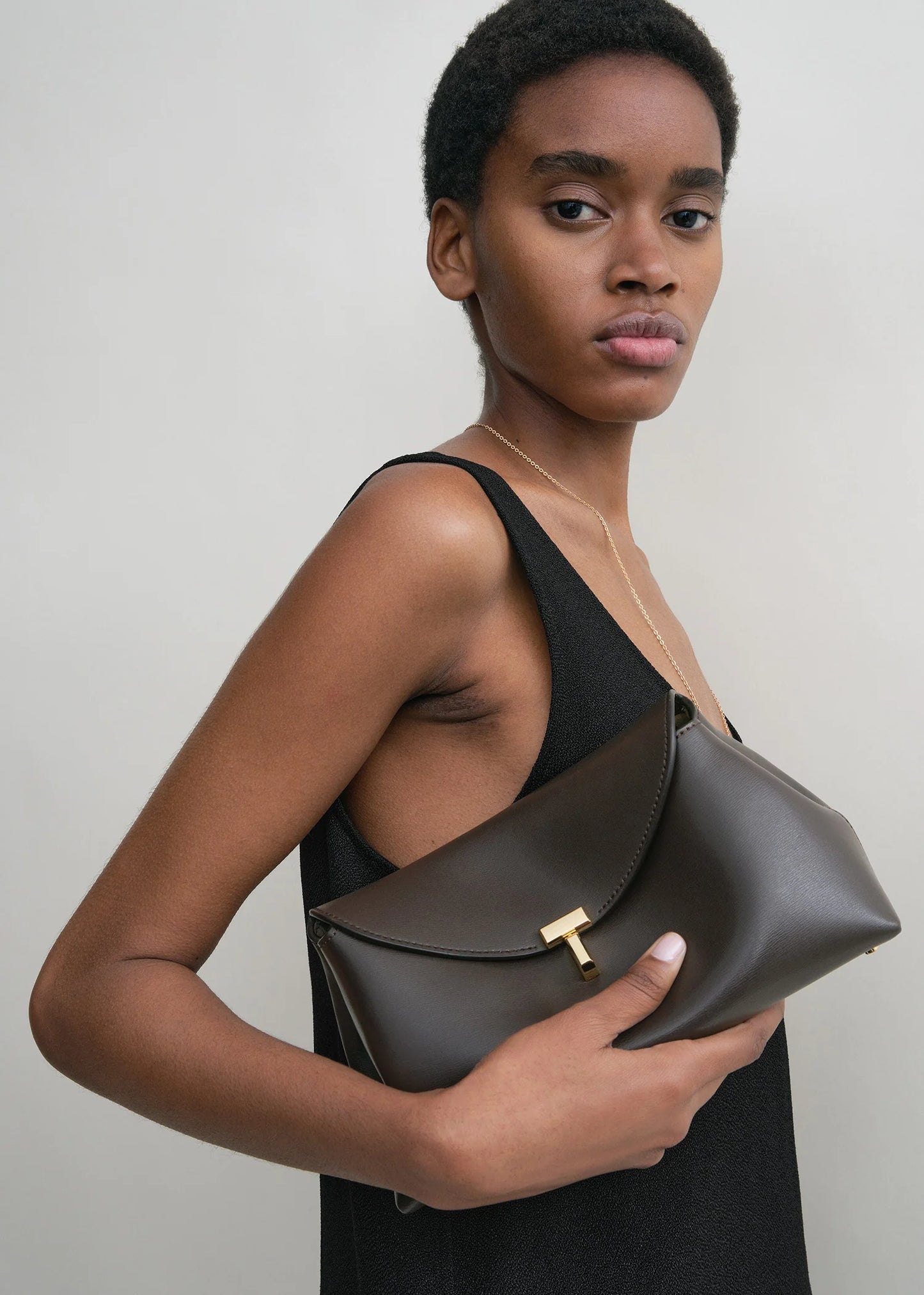 Toteme T-Lock leather clutch bark